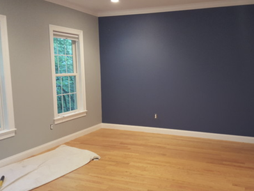 Freshly painted wall in gray with blue accent wall